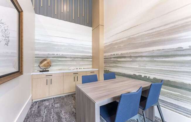 A conference room with a wooden table and blue chairs.