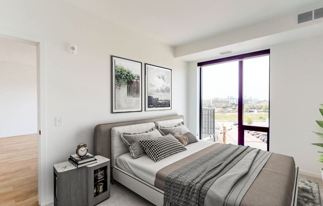 a bedroom with a bed and a large window