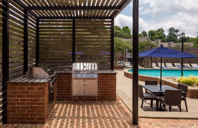 View of Grilling Lounge, Showing Grills, Pergola, and Picnic Area at Retreat at Peachtree City Apartments