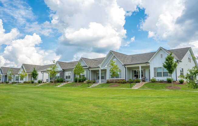 a row of houses with a green lawn in front of them