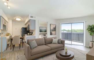 A living room with a couch, chairs, and a coffee table.