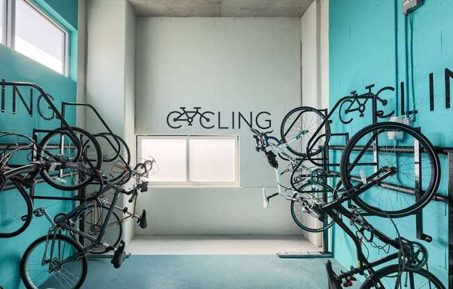 A room full of bicycles with a sign that says cycling.