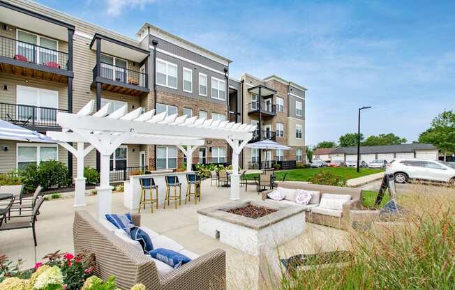 A sunny day at a residential outdoor patio with a white pergola.