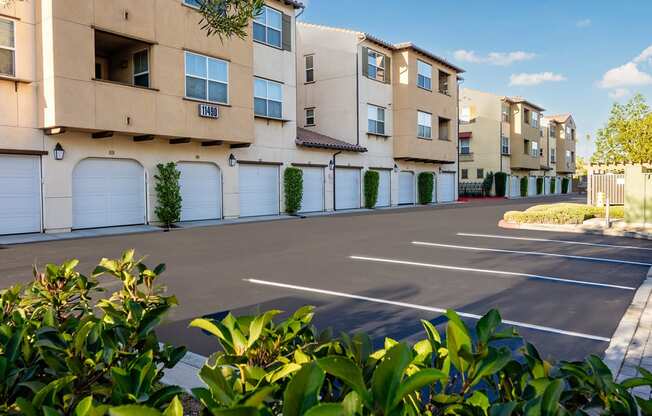 an empty parking lot in front of an apartment building