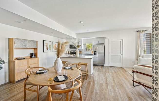 a living room and dining room with a table and chairs