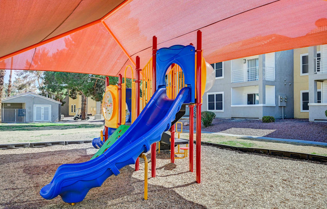 A blue and yellow slide in a playground.