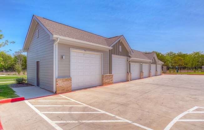 a row of garages at the whispering winds apartments in pearland, tx