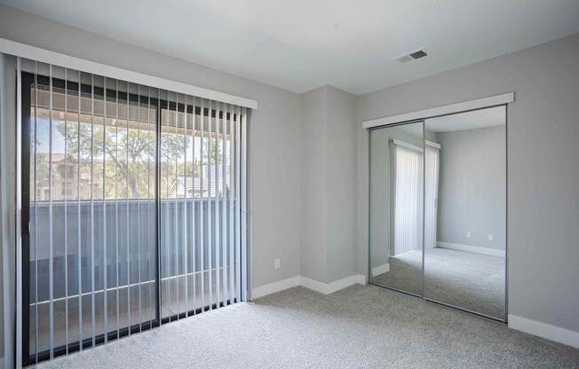 the master bedroom has sliding glass doors to the patio