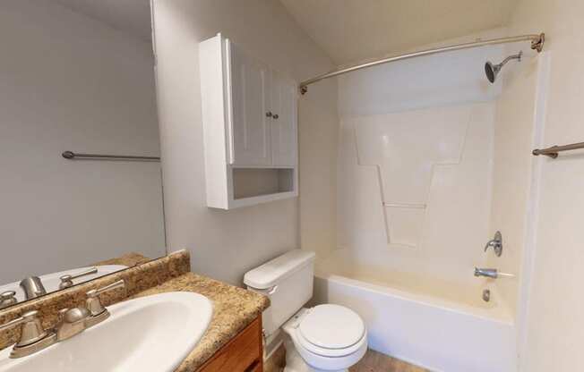 a bathroom with a sink toilet and a bath tub