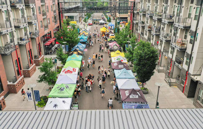 A street market with many people walking around.