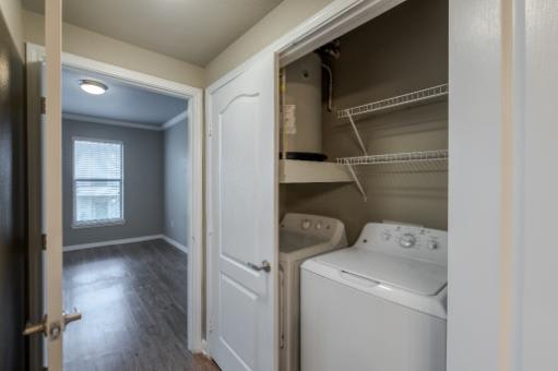 A small laundry room with a washer and dryer.