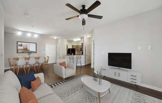 a living room with a couch and a tv at MetroPlace at Town Center, Maryland