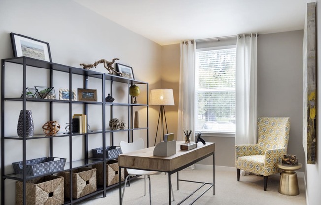 a home office with a desk and a shelving unit