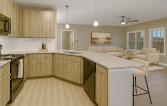 A kitchen with wooden cabinets and a marble countertop.
