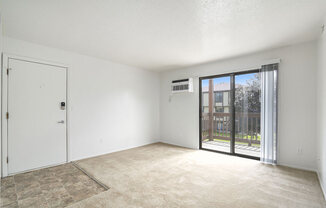 living room with a door to a balcony at Apple Ridge Apartments, Michigan, 49534