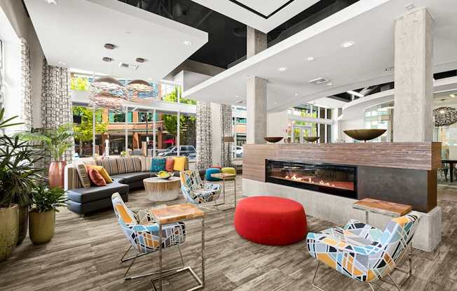 the lobby of a hotel with a fireplace and seating