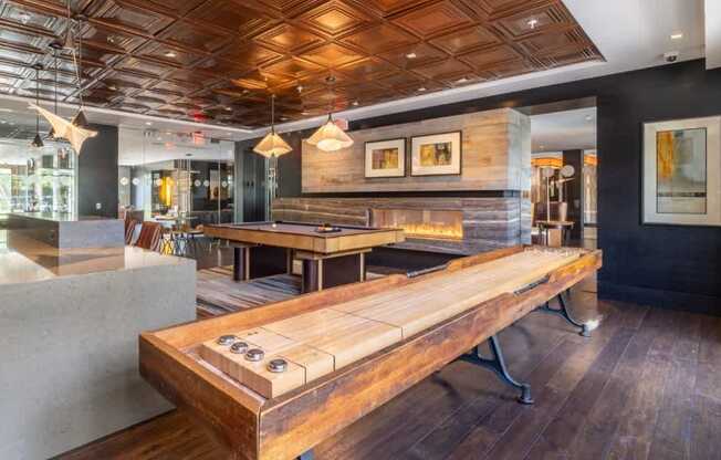 A room with a wooden table and bench in the foreground.