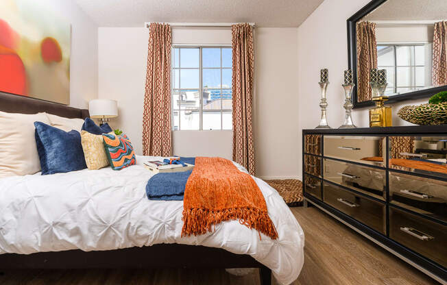 Apartments In Miracle Mile, Los Angeles, CA - The Preston Miracle Mile - Spacious Bedroom With High Ceilings, Plank Wood Style Flooring, And A Window