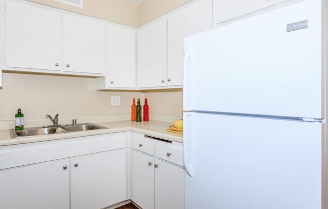 a white refrigerator freezer sitting inside of a kitchen