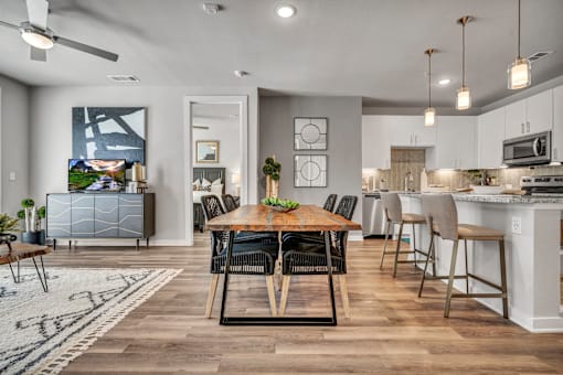 A modern dining room with a wooden table and chairs.