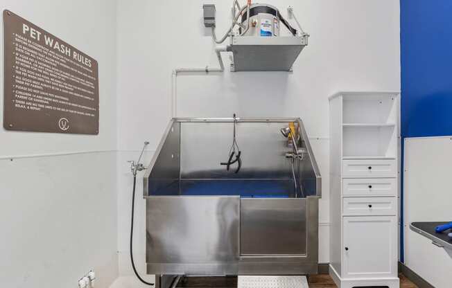 a sterilization unit in a hospital room with a sink and a tub of water