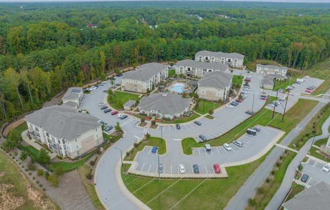 an aerial view of a community with houses and parking lot