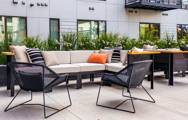 a seating area with couches and chairs on a patio