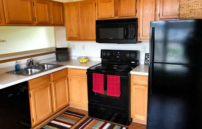 upgraded black kitchen appliances in village green at centennial park