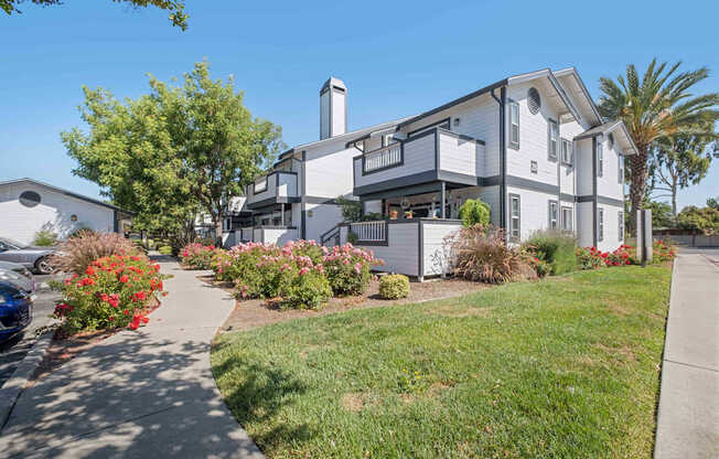A modern two-story house with a balcony and a chimney.