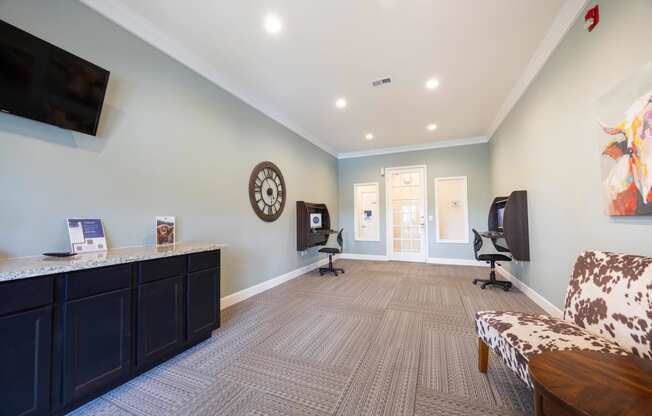 a living room with a couch and a desk with a tv