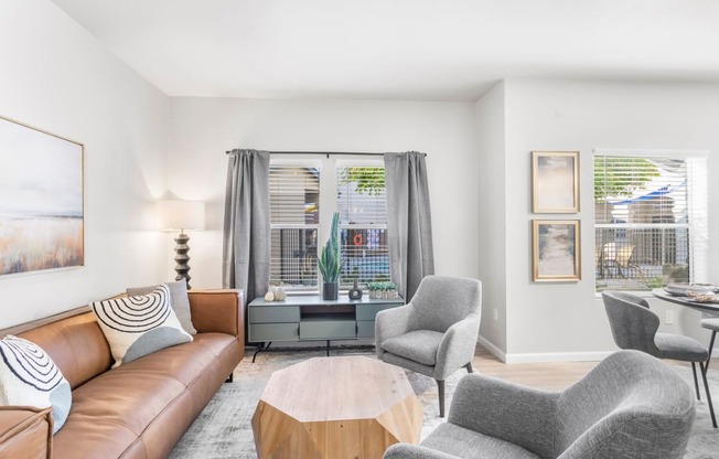 a living room with a couch and two chairs