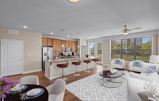 a living room and kitchen with a large window