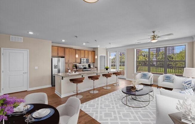 a living room and kitchen with a large window