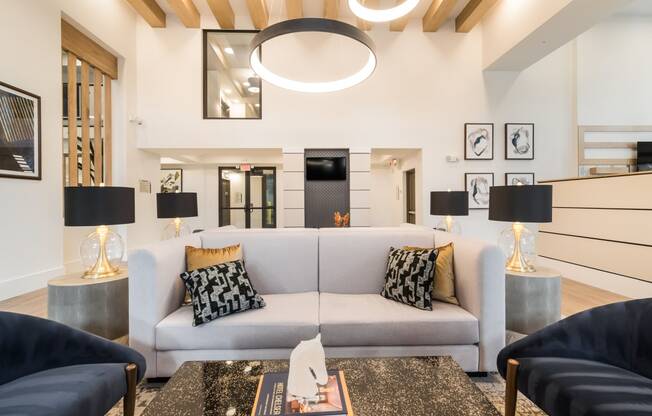 white couch with pillows and lighting above at Magnolia Square, Naples