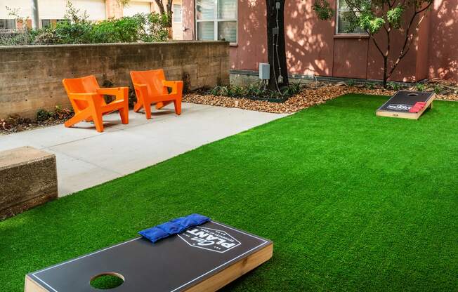 a backyard with artificial turf and a ping pong table