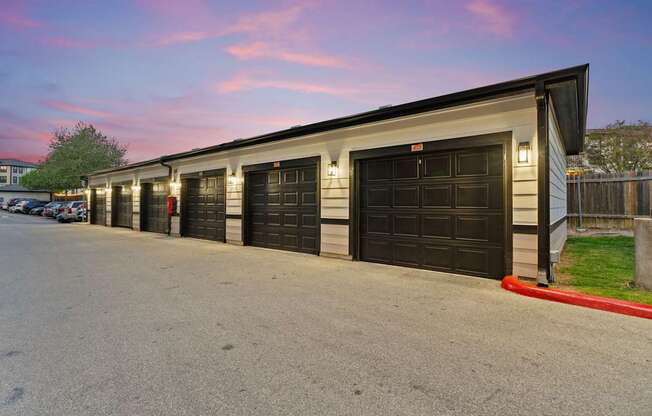 A long building with black garage doors.