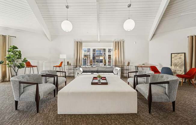A room with a white table and chairs with a carpet on the floor.