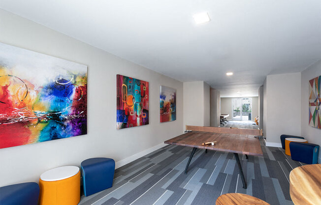 a conference room with a table and paintings on the wall at Aster Apartments, Beachwood, 44122