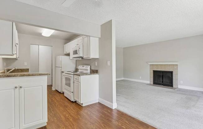 a view of a kitchen and a living room with a fireplace at Summerwood Apartments, California, 95050