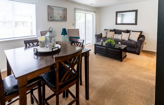an open living room and dining room with a couch and a table