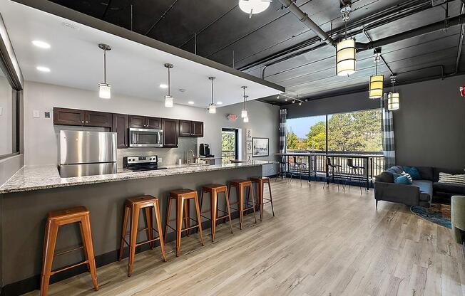 a kitchen with a bar and stools at Troy Place Apartments - Troy, MI, Michigan