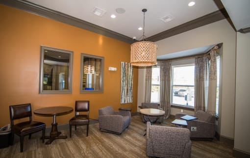 a living room with chairs and tables and a large window at Echo at Lake Norman, Mooresville, NC