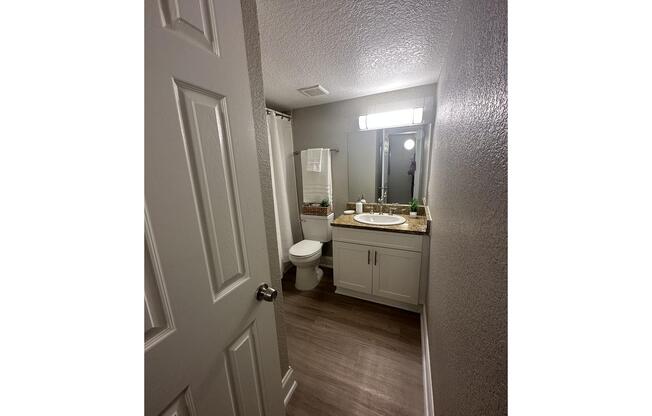 a room with a sink and a mirror