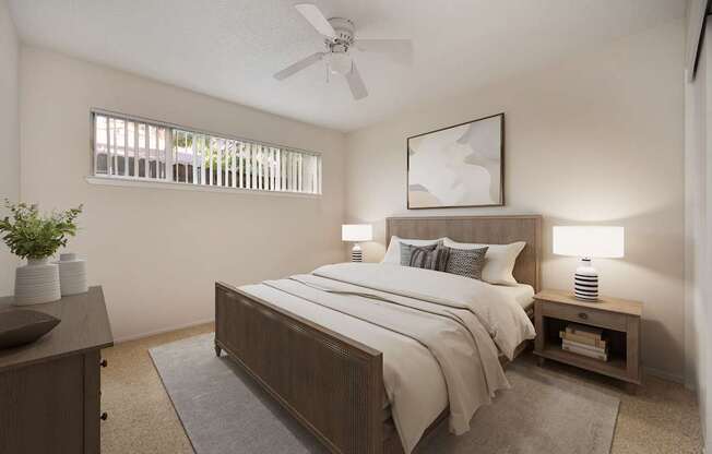 A bedroom with a bed, nightstand, and a ceiling fan.