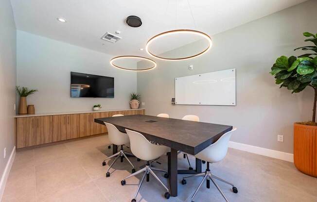 A conference room with a large table and chairs.