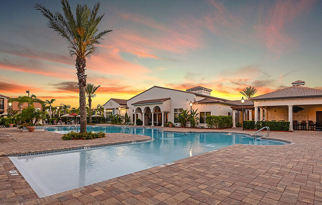 a home with a swimming pool in front of a sunset  at Hacienda Club, Jacksonville, 32256
