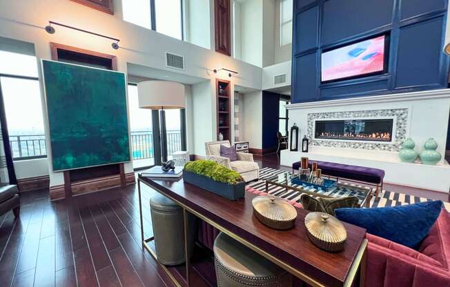 a living room with a long wooden table and a fireplace