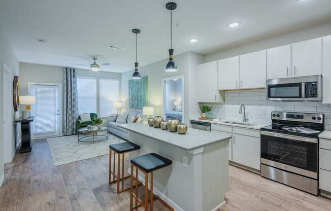 kitchen with custom cabinets, large island, and stainless steel appliances at Bon Haven Apartments in Spartanburg, SC