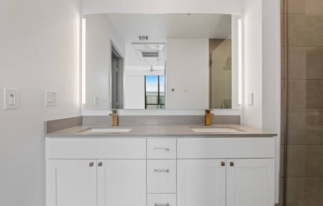 a bathroom with two sinks and a large mirror