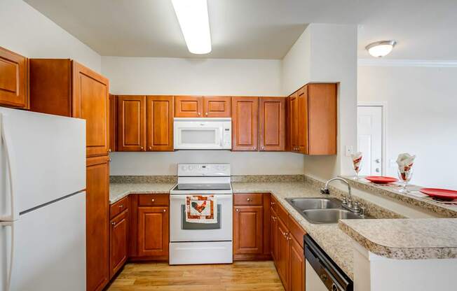 A kitchen with wooden cabinets and a white refrigerator.